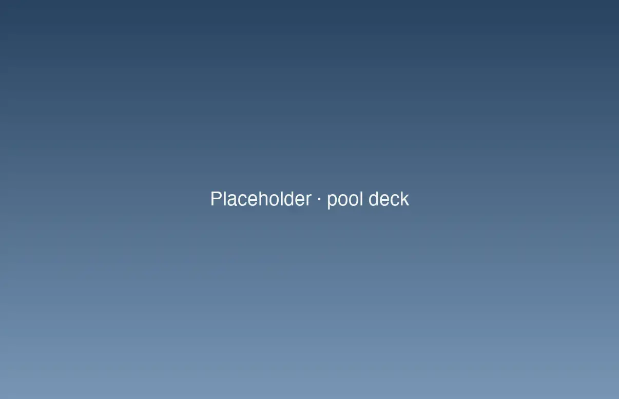 Light paver pool deck with lounge chairs surrounding a rectangular pool